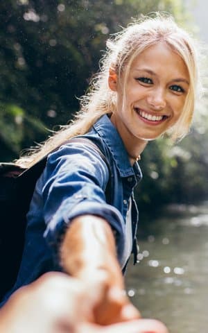 young woman inserting Invisalign aligner